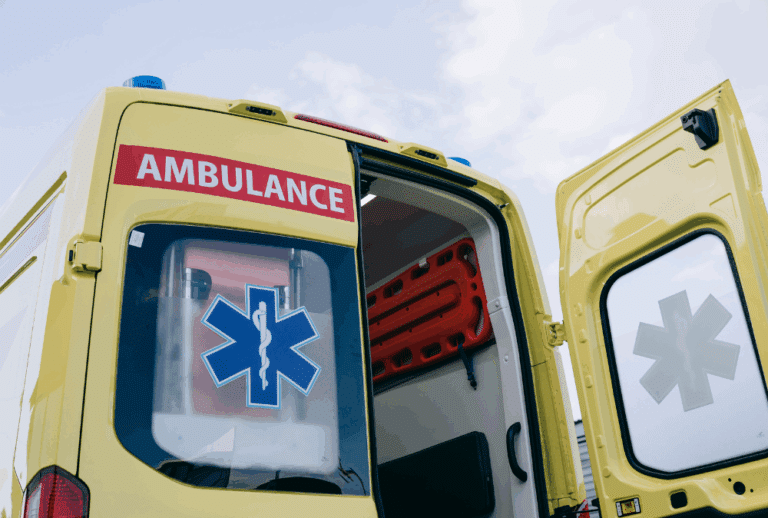 Image is of the back of a yellow ambulance with the door open, concept of Melbourne catastrophic injury lawyer