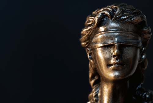 Image is of a closeup the head and face of a statuette of Lady Justice, concept of Melbourne drug trafficking lawyer