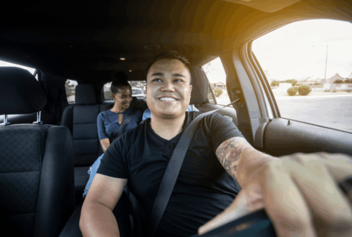 Image is of a rideshare driver with passengers in the backseat, concept of Melbourne Uber accident lawyer