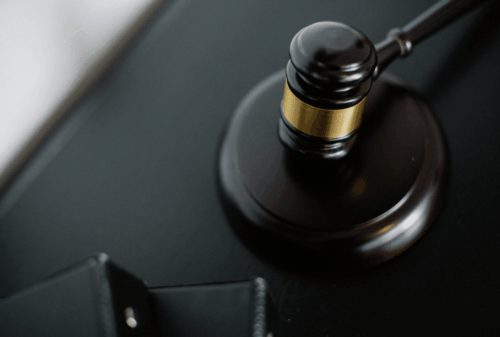 Image is of a closeup of a judge's gavel on a desk, concept of Melbourne wrongful death lawyer