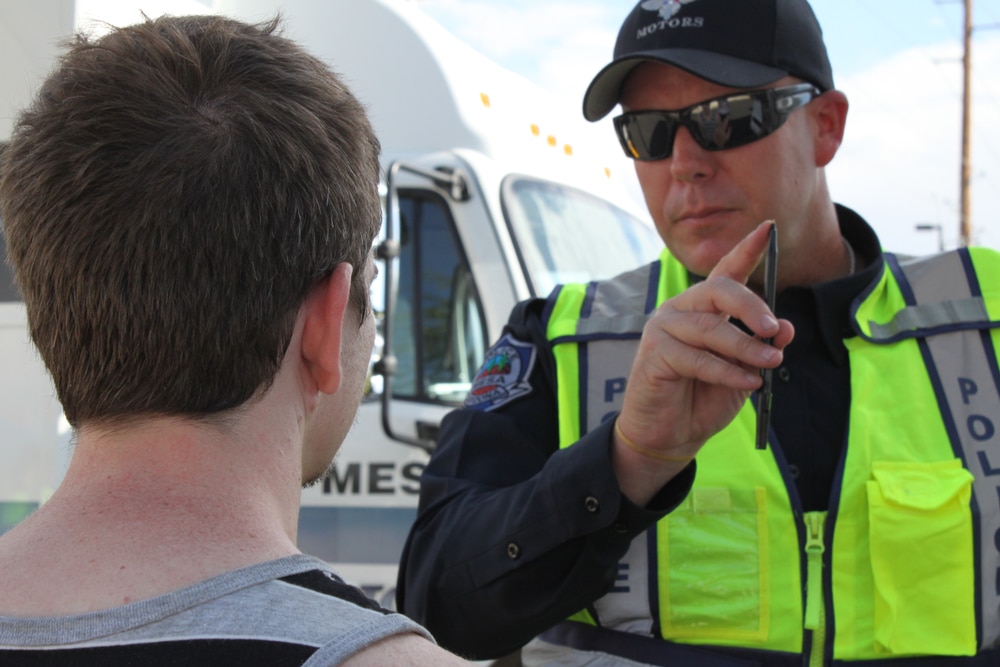 police officer giving young man a field sobriety test, dui defense lawyer