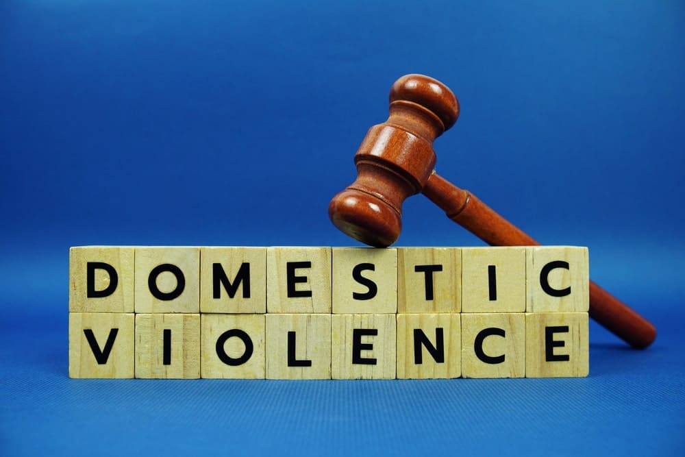 Gavel with blocks spelling domestic violence.