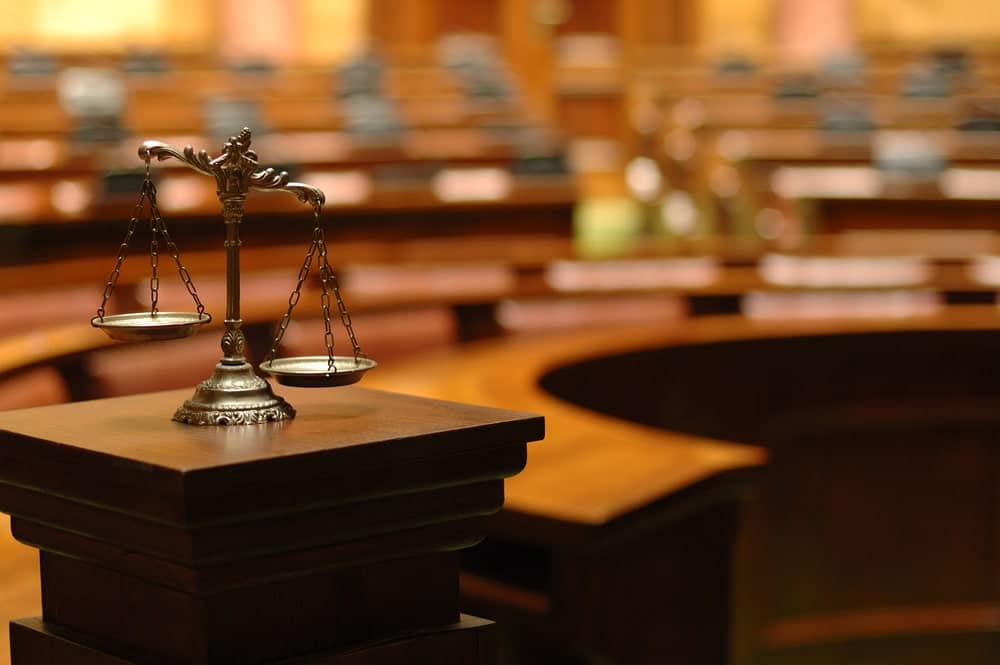 Scales of justice in courtroom representing legal balance and court proceedings