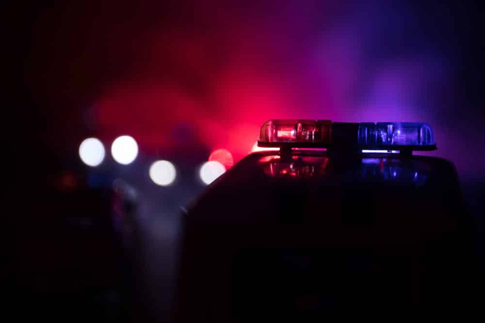 Image is of flashing police lights on a patrol vehicle at night, representing law enforcement response to multiple DUIs in Florida.