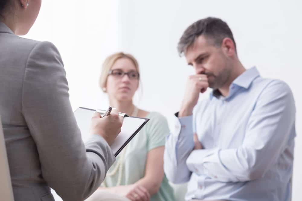 Image is of a couple meeting with a mediator during a legal consultation, concept of DV cases in Cocoa Beach and structured mediation guidance.