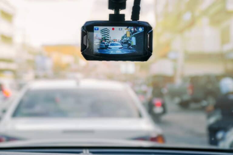Image is of a dashboard camera recording traffic footage during roadway monitoring, concept of DUI defense.