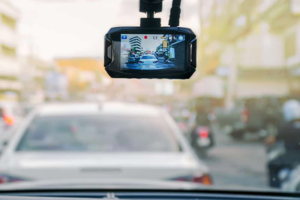 Image is of a dashboard camera recording traffic footage during roadway monitoring, concept of DUI defense.