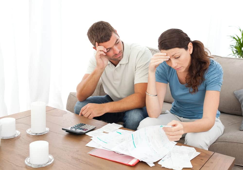 Image is of a couple examining bills and household expenses together, concept of domestic violence in Cocoa Beach and financial control within a relationship.