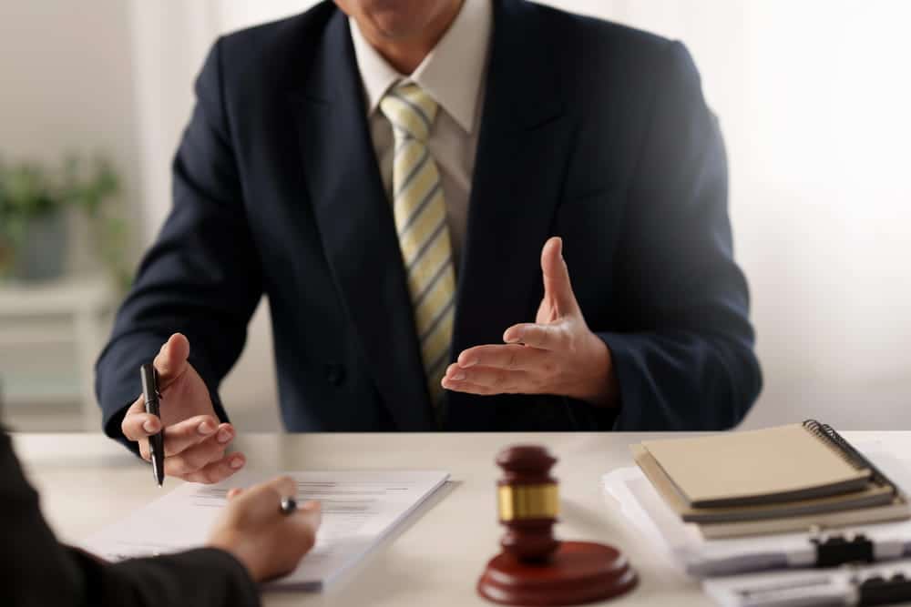 Image is of a lawyer meeting with a client to discuss a Cocoa Beach DUI case.