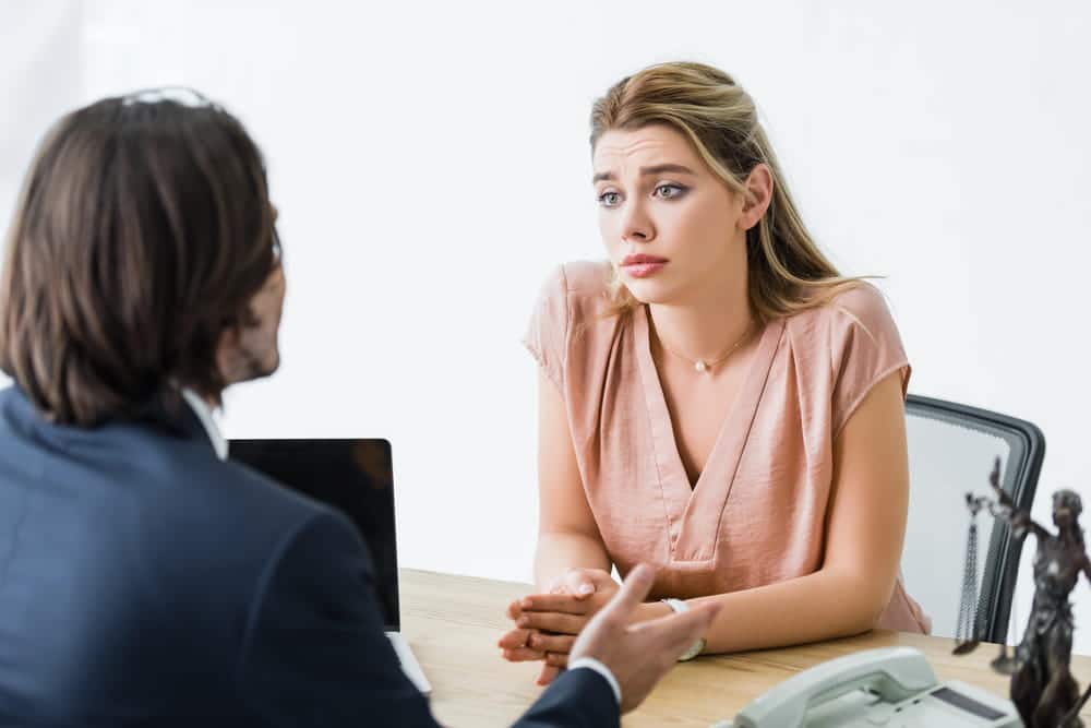 Image is of a woman meeting with an attorney in an office, concept of understanding victim rights after domestic violence in Cocoa Beach.