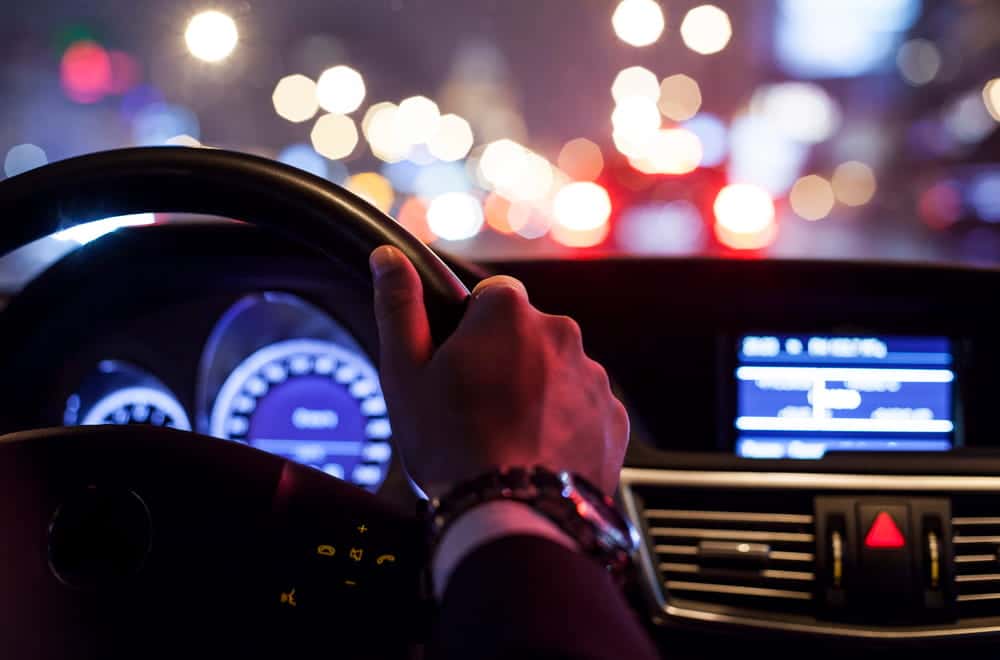 Image is of a person driving through traffic at night, concept of DUI reduction to reckless driving in Cocoa Beach