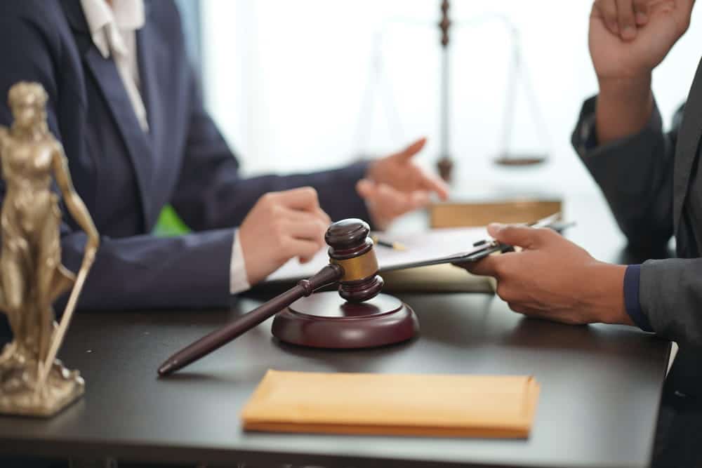 Image is of an attorney discussing legal matters with a client, concept of child custody in Cocoa Beach after a DUI arrest.