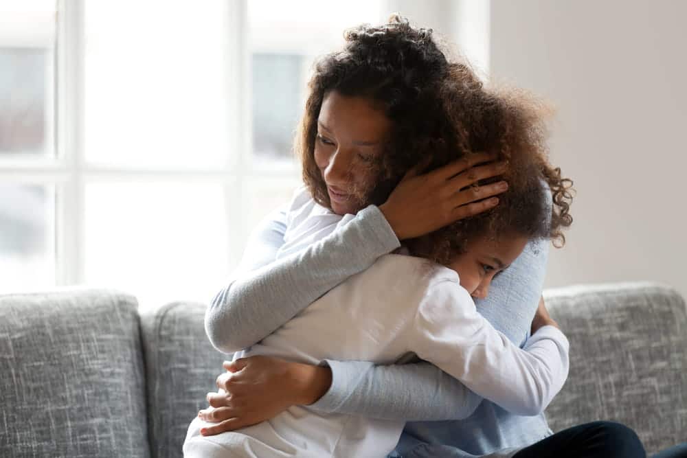 Image is of a mother comforting her child during a difficult family situation, concept of restricting visitation after DV in Cocoa Beach