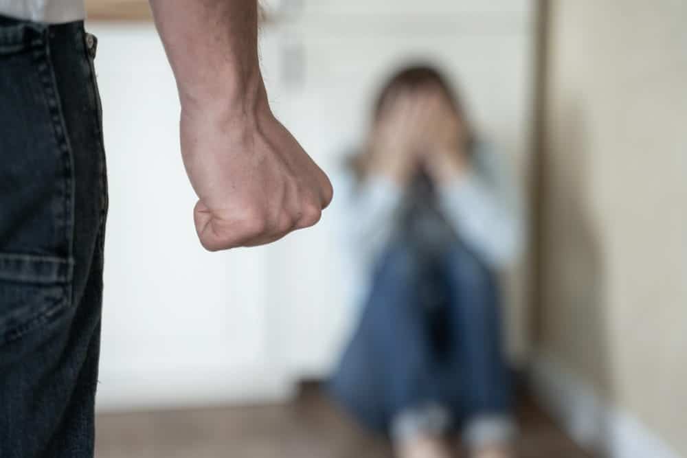 Image is of a person facing a frightened partner, illustrating how someone can be arrested for DV without visible injuries.