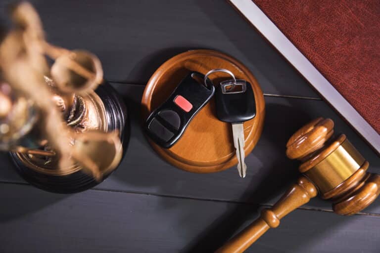 Image is of a judge’s gavel, car keys, and legal items representing the timeline and process of a DUI case in Cocoa Beach