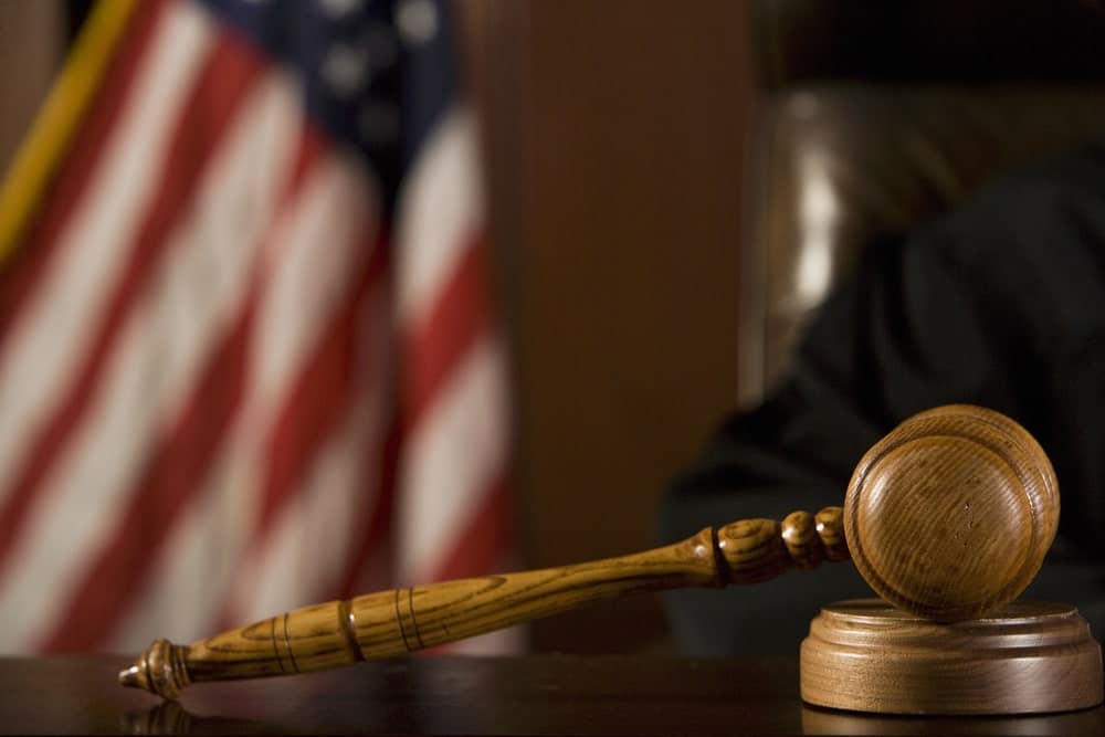 Image is of a courtroom gavel with an American flag, concept of a DV bond hearing in Cocoa Beach.