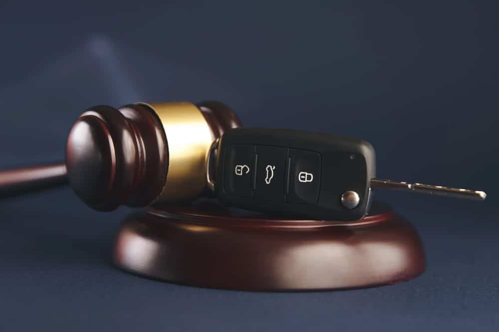 Image is of a car key resting against a judge's gavel, concept of legal evidence required to prove a Cocoa Beach DUI charge.